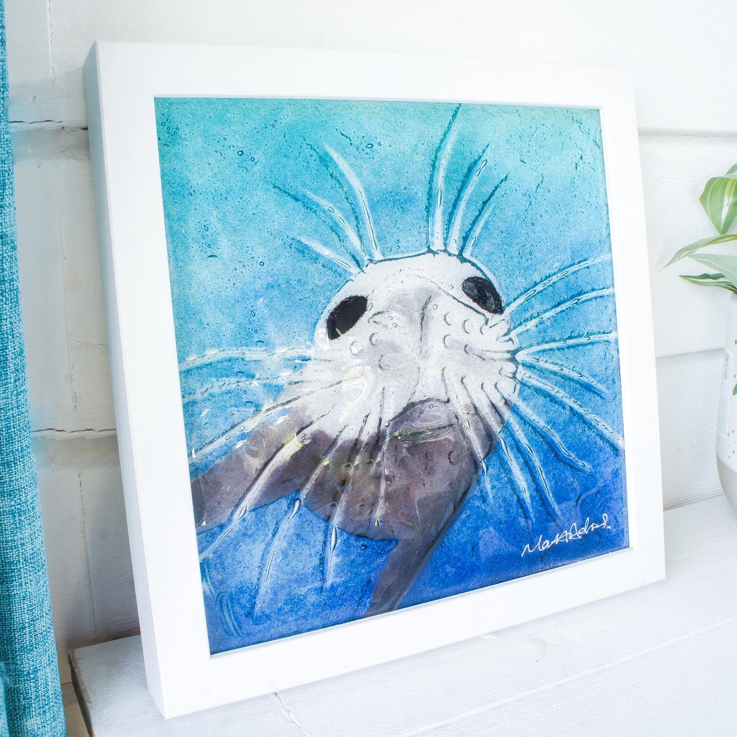 seal face fused glass art frame 25cm 10" blue teal water, underwater animal, animal print, wall art, pictureframe, unique wall art, wall hanging, handmade wall decor, vibrant piece of art, sea animal turquoise decor, sealface with moustache, cute art, seal swimming in deep sea