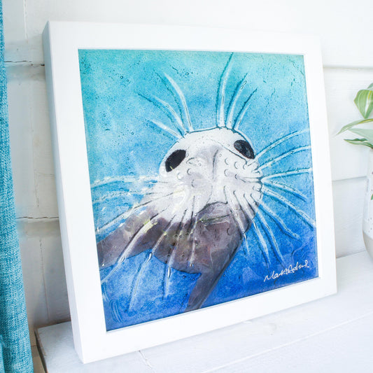 seal face fused glass art frame 25cm 10" blue teal water, underwater animal, animal print, wall art, pictureframe, unique wall art, wall hanging, handmade wall decor, vibrant piece of art, sea animal turquoise decor, sealface with moustache, cute art, seal swimming in deep sea